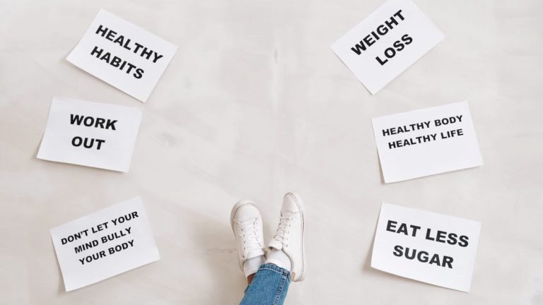 Inspirational health and fitness messages with shoe-clad feet, promoting healthy habits and wellbeing.